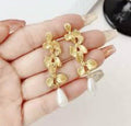 Elegant long floral drop earrings with pearl accents