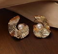 Spiral swirl gold earrings with central pearl