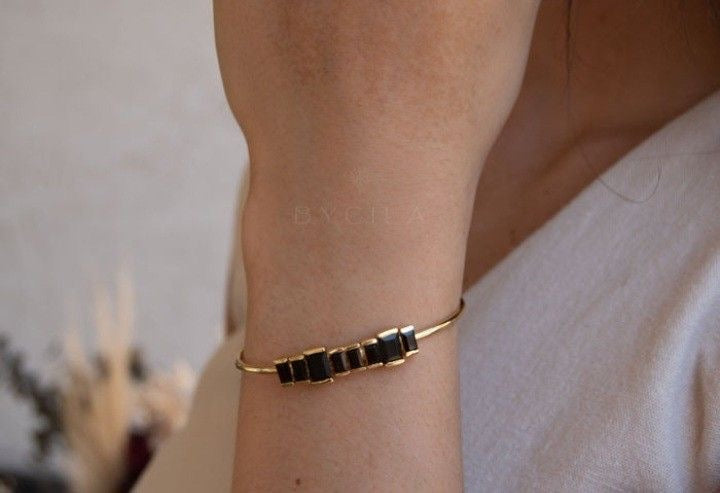 Golden bracelet with black stone