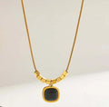 Square black pendant with golden necklace
