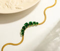 Golden bracket with green crystal stone