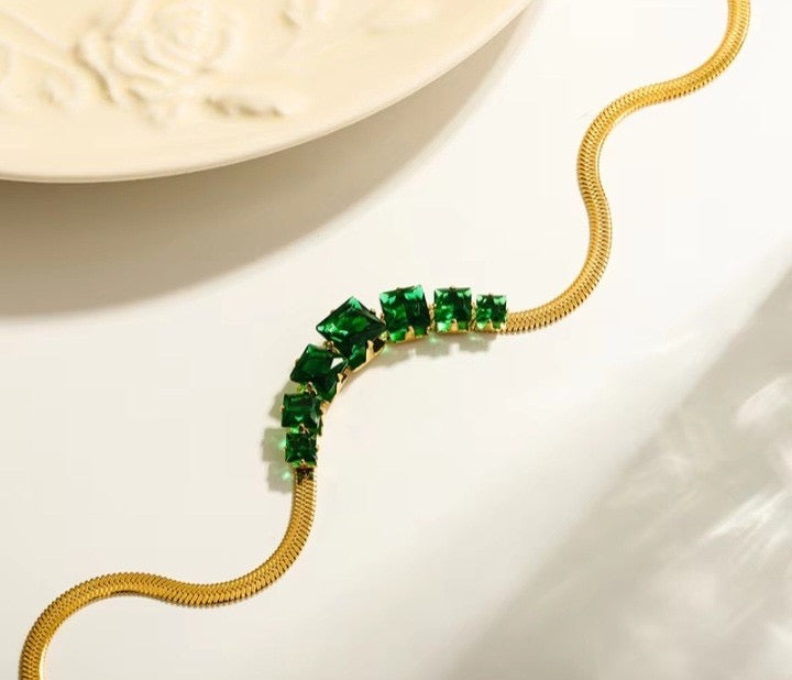 Golden bracket with green crystal stone