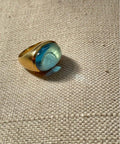 Golden ring with bold dome deep blue -green ring